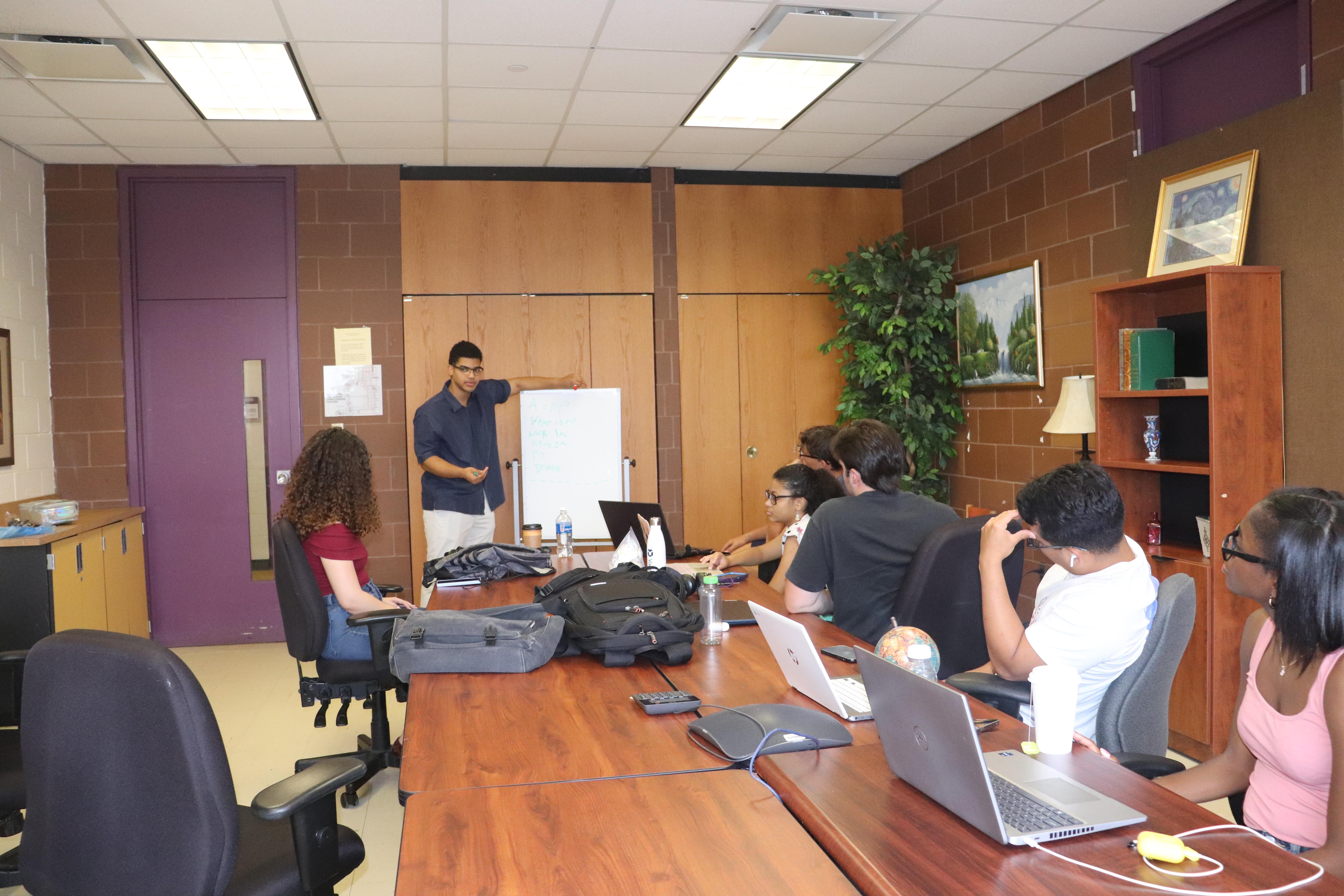 BCC student developer and researchers inspecting growing systems and crop health in the hydroponics facility